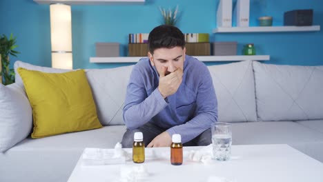 Young-man-with-health-problems-sneezes-and-blows-his-nose.